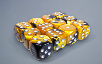 Twelve gold and black marbled dice with silver pips are clustered on a gray surface