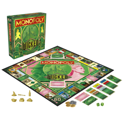 A Monopoly Wicked Edition game set, featuring a green box, board with Elphaba and Glinda art, gold tokens, cards, and dice laid out