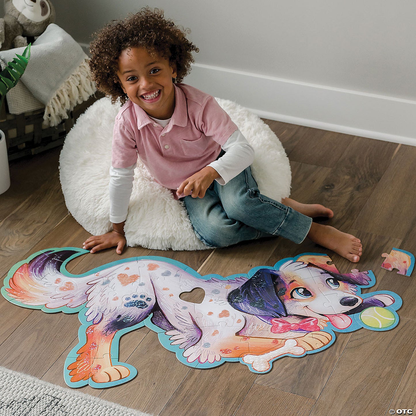 Child assembling Puppy puzzle on the floor