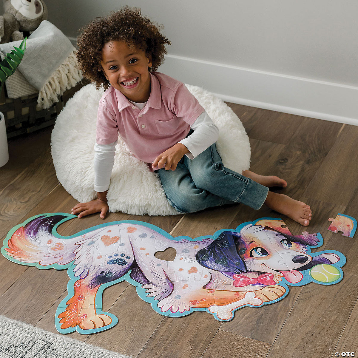 Child assembling Puppy puzzle on the floor