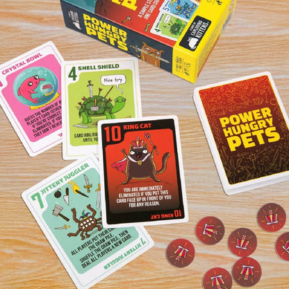 Power Hungry Pets card game components: box, tokens, and multiple cartoon cards, including the King Cat card