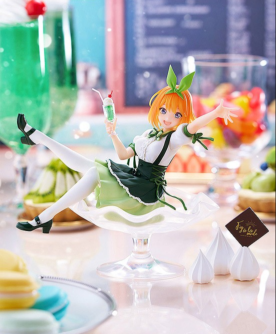 Anime figure in a green maid dress sitting in a glass dessert bowl holding a drink