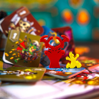 Colorful board game pieces including red antlers and a yellow figure on game cards