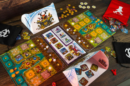 Colorful board game laid out on a wooden table with game boards cards tokens and drawstring bags