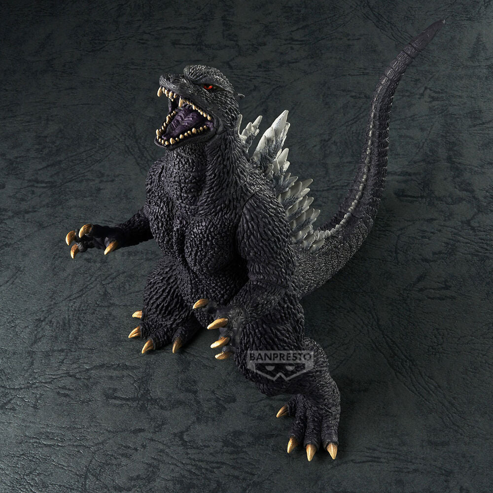 Black Godzilla action figure roaring, showing sharp teeth, white dorsal fins, and golden claws