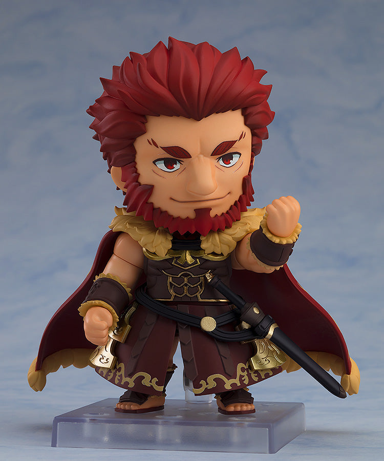 Good Smile Company Nendoroid Rider Iskandar figure from FateGrand Order The collectible has red hair a beard armor and a sword posed dynamically on a clear stand