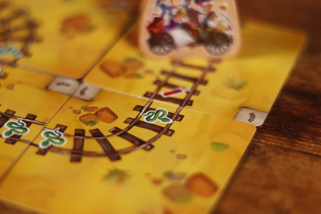 Close-up of Infernal Wagon game cards laid out during play
