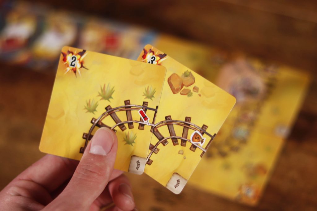 Infernal Wagon card game with tokens and character cards on table