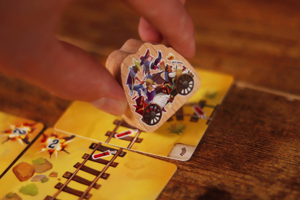 Game components of Infernal Wagon including cards and player tokens