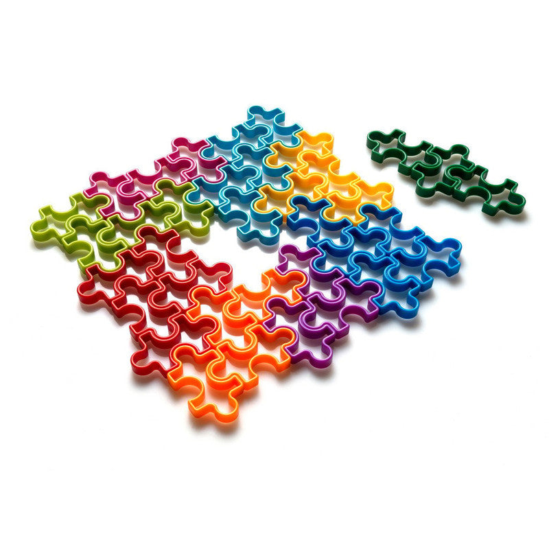 Colorful interlinking cookie cutters forming a partial jigsaw puzzle
