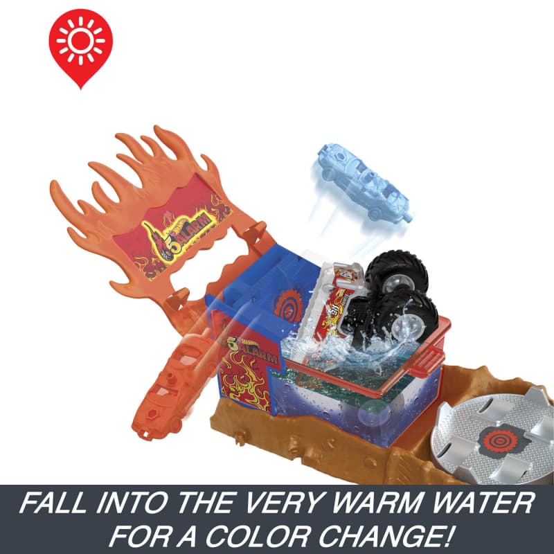 Hot Wheels 5 Alarm playset. A blue car flies above while a black monster truck splashes into a warm water tank for color change