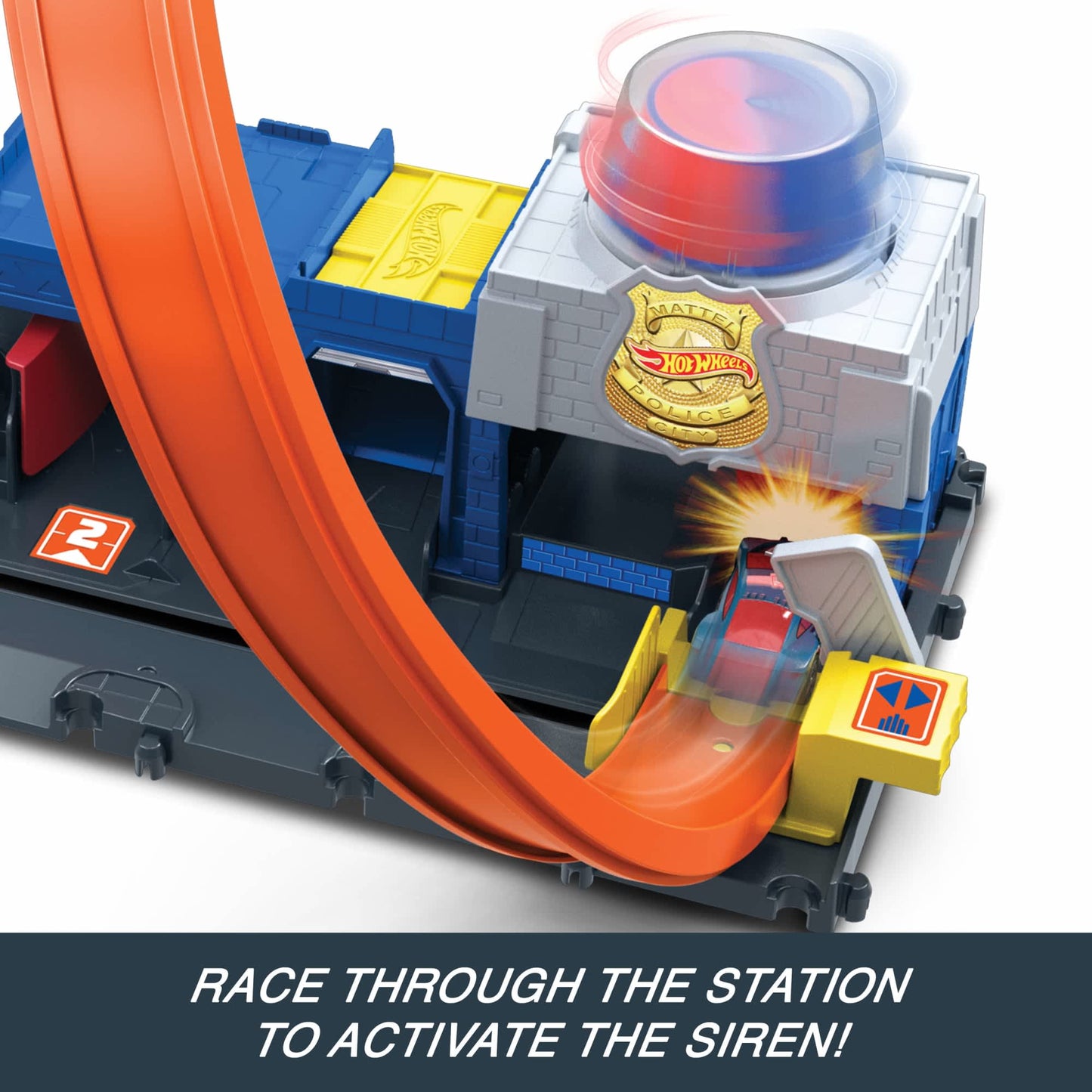 A red car races on an orange track toward the Hot Wheels City Super Police Station, activating its spinning red and blue siren
