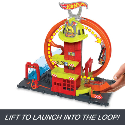 Hot Wheels City Super Loop Fire Station playset  with an orange loop and water effect. A hand launches a toy fire truck into the loop