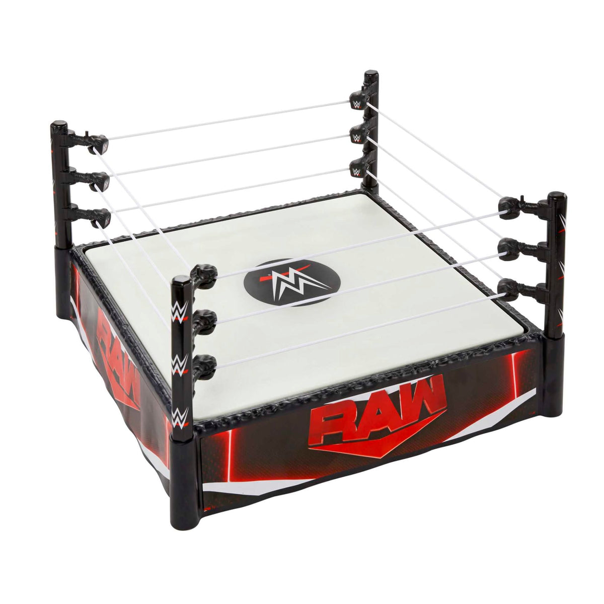A toy WWE wrestling ring with a white mat, black posts, and &quot;RAW&quot; branding on the skirt