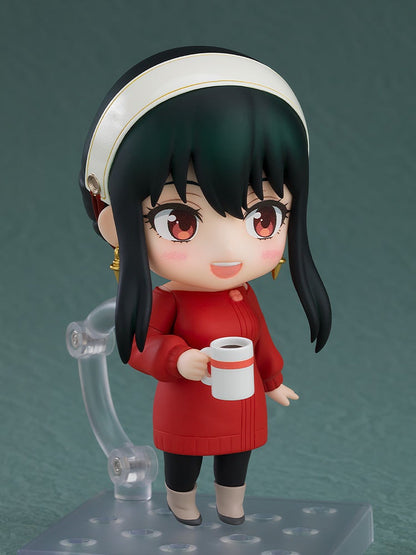 Nendoroid Yor Forger in a red sweater dress and white headband, smiling and holding a mug