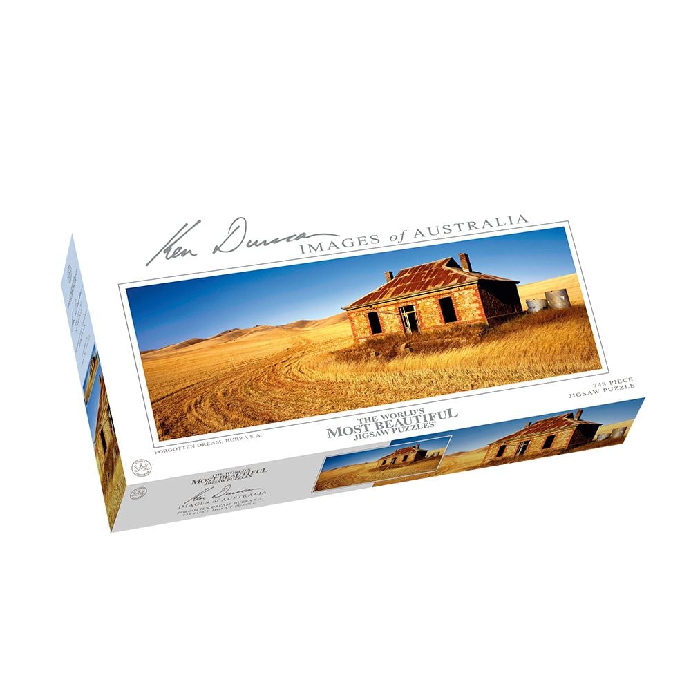 Jigsaw puzzle box with an image of a dilapidated stone house in a golden, dry Australian field