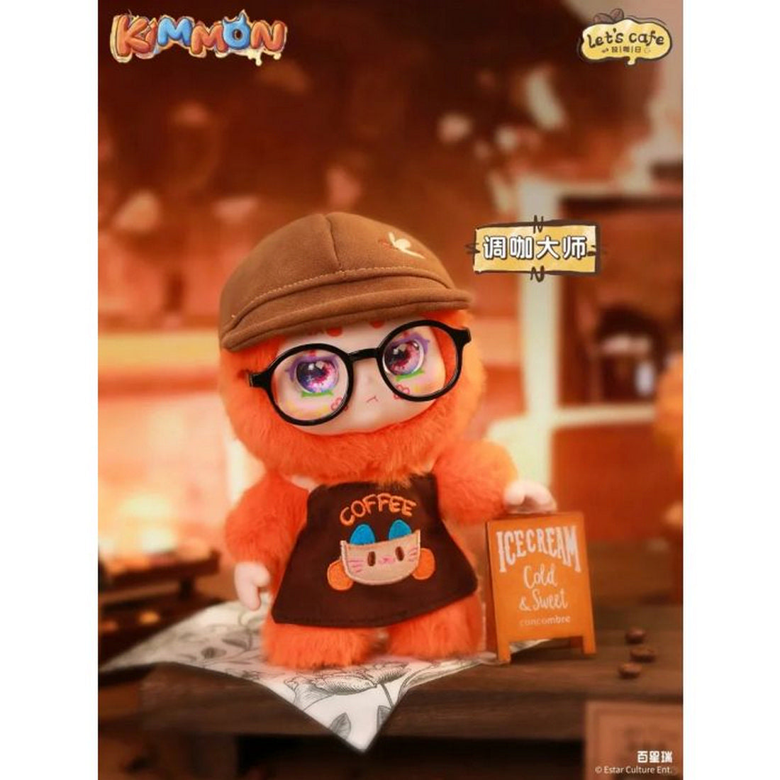 Fuzzy orange Kimmon barista doll wearing glasses, a cap, and a coffee apron next to an ice cream sign