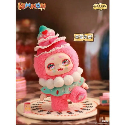 Fuzzy pink Kimmon figure dressed as a strawberry pastry, featuring a layered hat and big, sparkly eyes