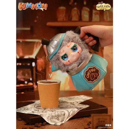 Plush Kimmon character shaped like a Moka pot, pouring coffee into a paper cup