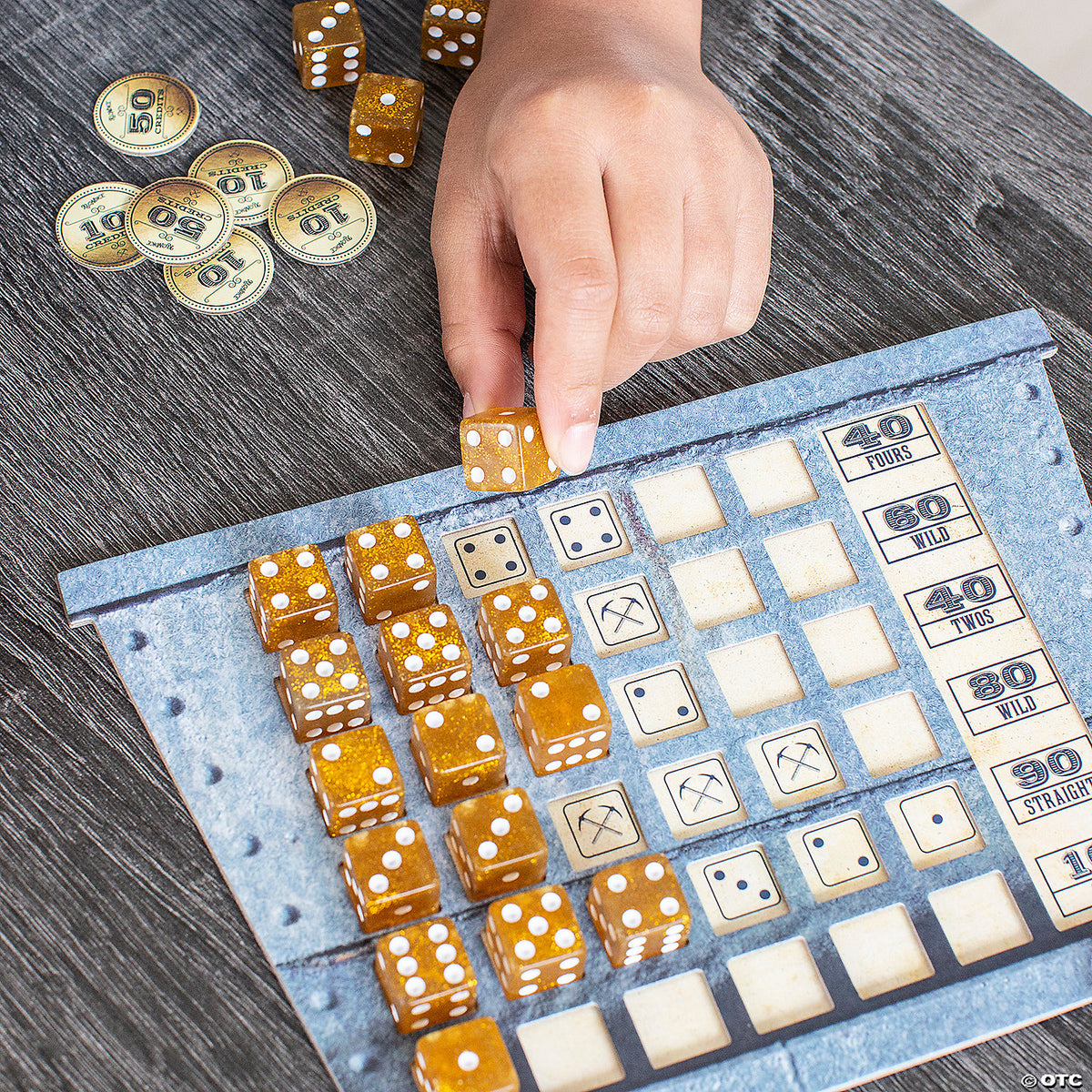 Close-up of game setup showing carts loaded with gold tokens and custom dice