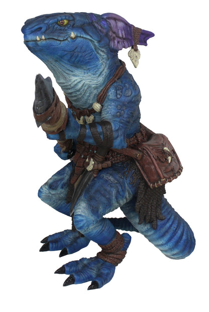 Crouching blue reptilian kobold figure with yellow eyes, holding a blade. Wears leather straps and a hip pouch