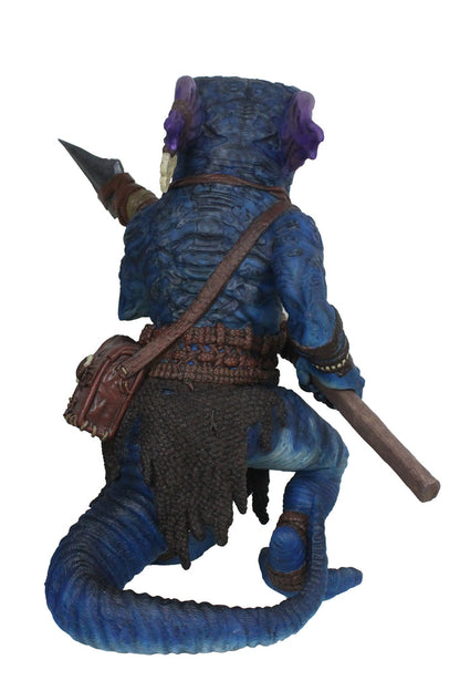 A blue, scaly reptilian kobold figure with purple ears and a tail, seen from behind, crouching and holding a spear