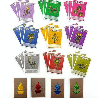 Close-up of playing cards featuring various Kokopelli-style tribal illustrations and game symbols