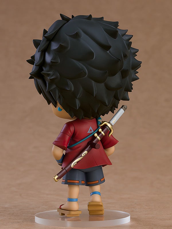 Chibi figure of a boy in a red shirt and gray shorts carrying a sword on his back