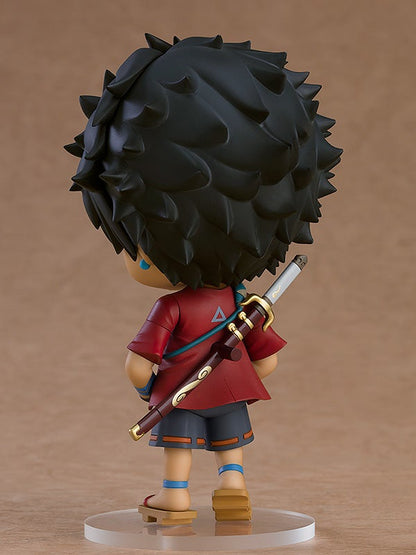 Chibi figure of a boy in a red shirt and gray shorts carrying a sword on his back