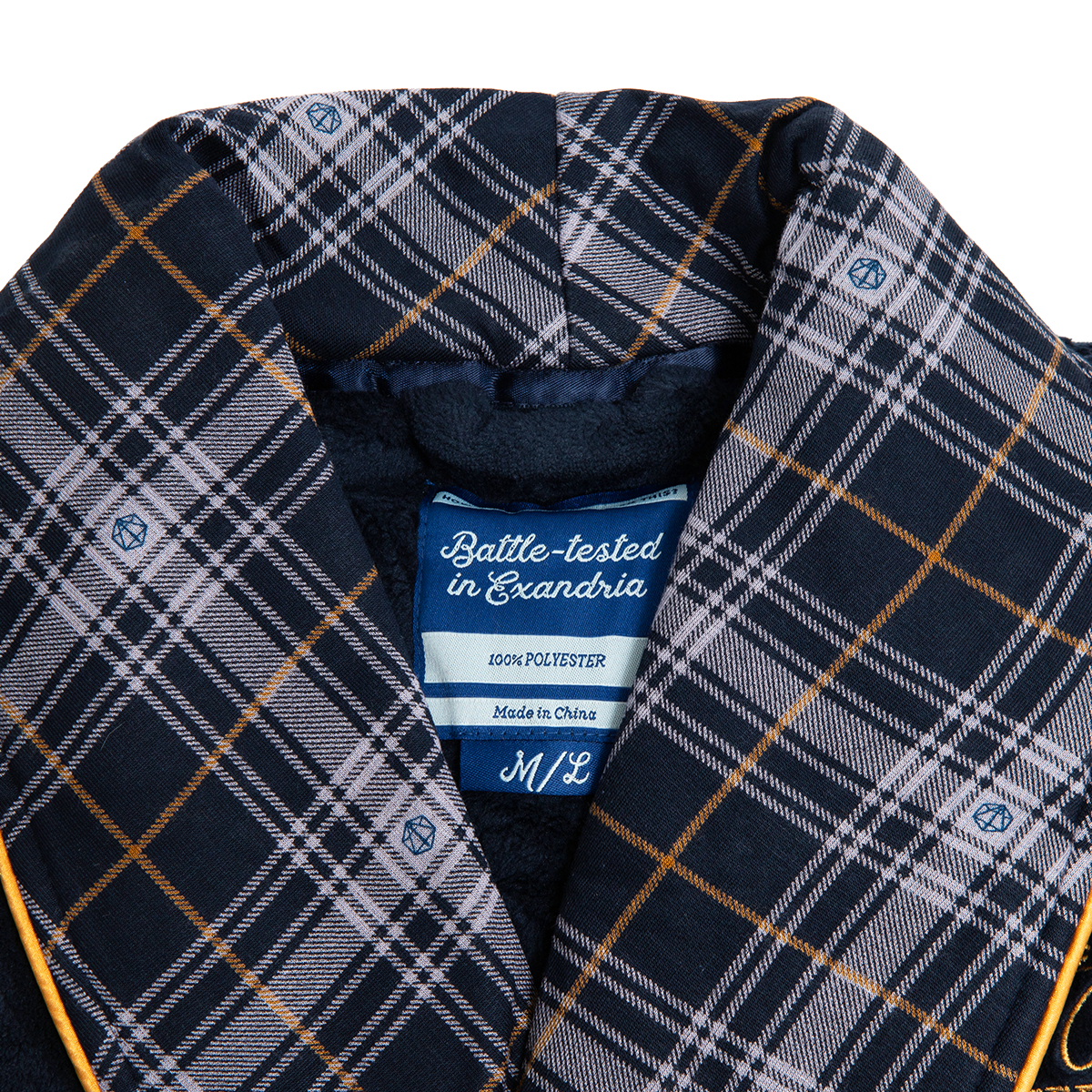 A close-up of a Navy blue, grey, and orange plaid robe with a fuzzy lining and small d20 dice details. A label reads "Battle-tested in Exandria"
