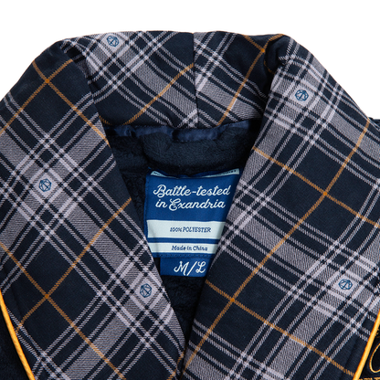 A close-up of a Navy blue, grey, and orange plaid robe with a fuzzy lining and small d20 dice details. A label reads "Battle-tested in Exandria"