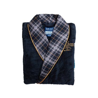 A folded navy blue  lavish chateau bathrobe with a plaid collar, gold trim, and "Chateau Entertainment" embroidered logo