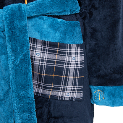 Close-up of a  navy blue lavish chateau bathrobe with teal accents, a plaid pocket, and a gold D20-like symbol
