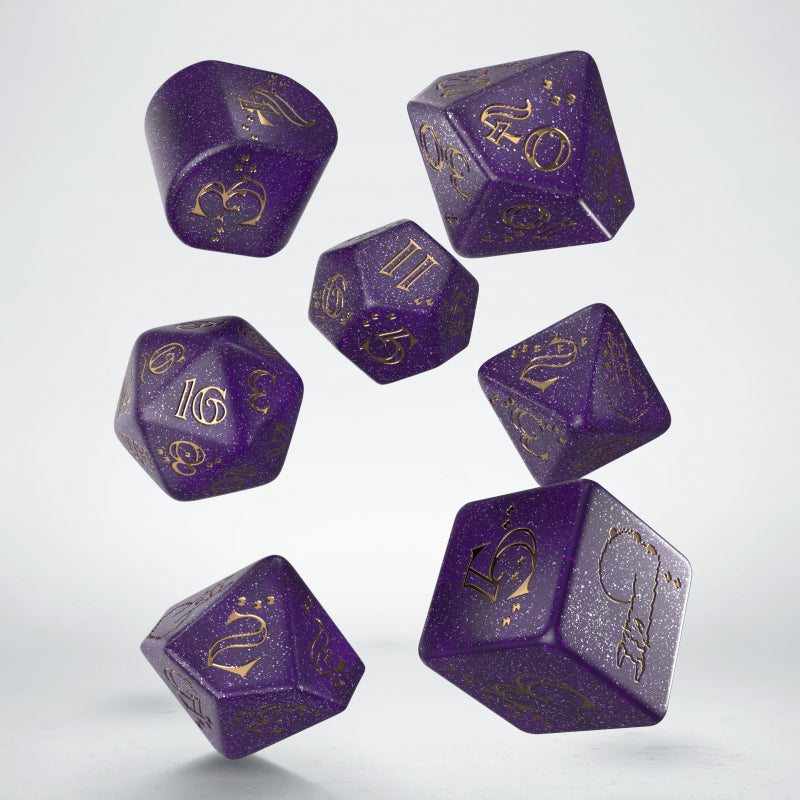 Seven speckled purple and gold polyhedral dice floating against a light background