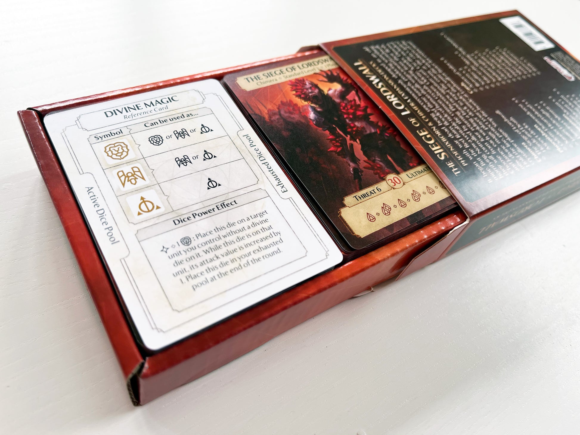Ashes Reborn The Siege of Lordswall 2 expansion box displaying Divine Magic reference card and Threat 6 card with ultimate ability icon