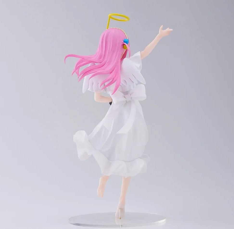 Rear view of seated figure showing hair detail and guitar strap over shoulder