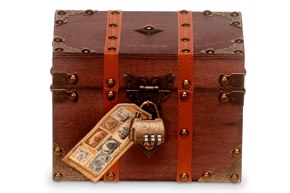 Antique wooden treasure chest with metal details, leather straps, a combination padlock, and a vintage stamp tag