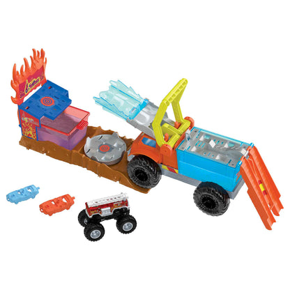Fire and ice monster truck playset with a large orange truck, ice blaster, yellow crane, a fire station target with water tank, spinning disc, small fire truck, and two colorful smash cars