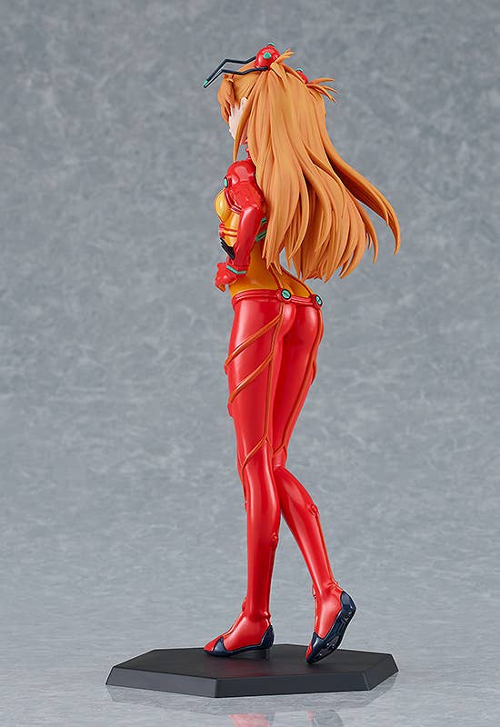 Collectible figure of Asuka in a red and orange plugsuit with flowing orange hair, looking over her shoulder
