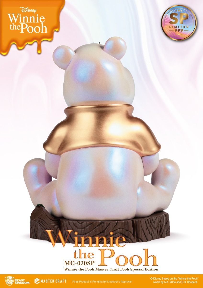 Iridescent white Winnie the Pooh collectible figurine with golden shirt sitting on a wood base special edition