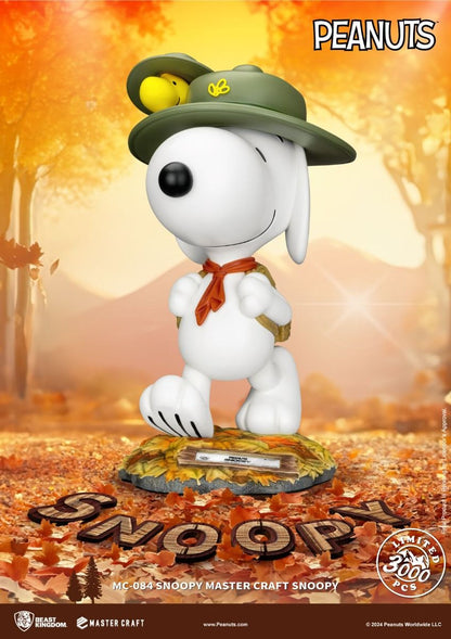 Limited edition Snoopy figurine as a scout in a green hat with Woodstock orange scarf and backpack walking on autumn leaves