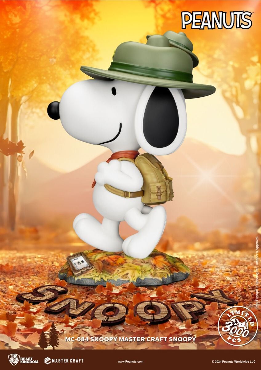 Snoopy Master Craft figure in green hat and backpack standing on a base of autumn leaves