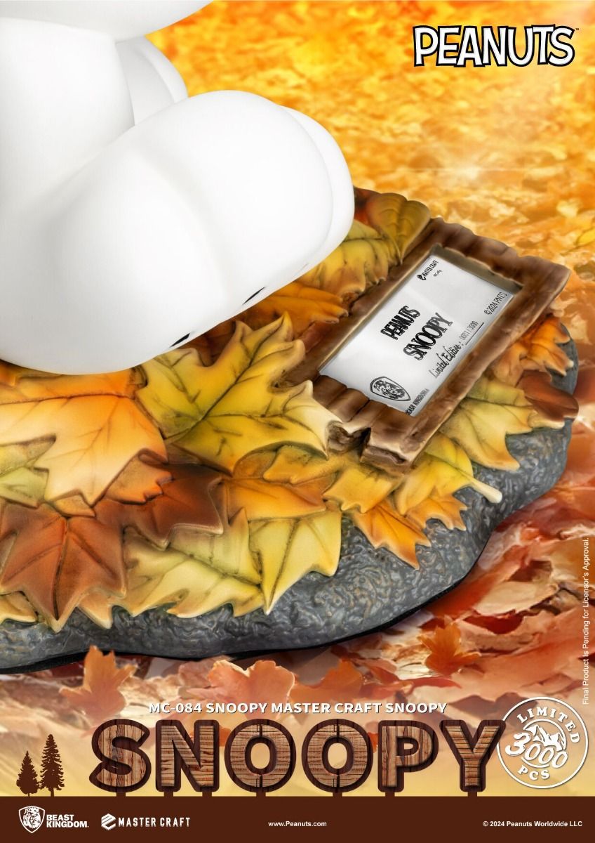 Snoopy Master Craft collectible statue in autumn setting with colorful fallen leaves and a certificate