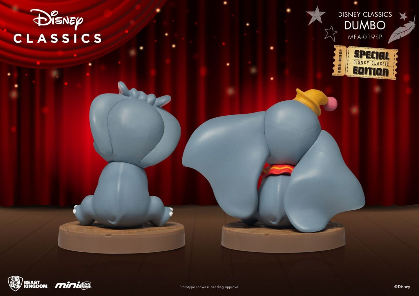 Two Dumbo figures from Disney Classics one sitting and one on its belly with trunk extended on brown bases