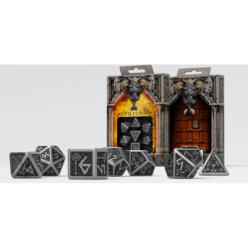 Grey metal polyhedral dice with engraved runes, displayed in front of two dwarf-themed stone box sets