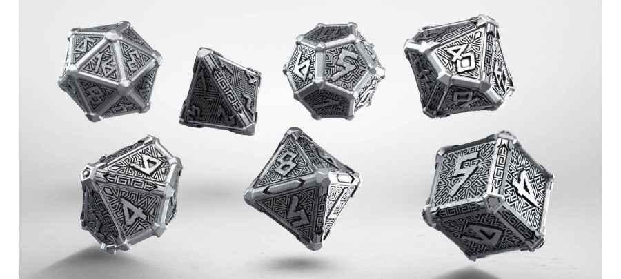 Seven metallic silver polyhedral dice with intricate engraved geometric and runic patterns appear to float against a light grey background