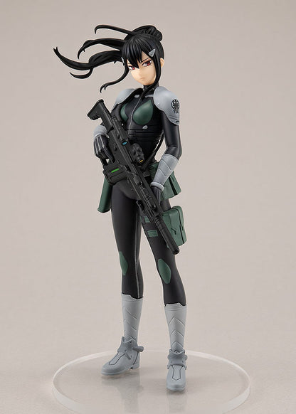 Side profile of Mina aiming a large pink bazooka-like weapon, with her right knee slightly bent