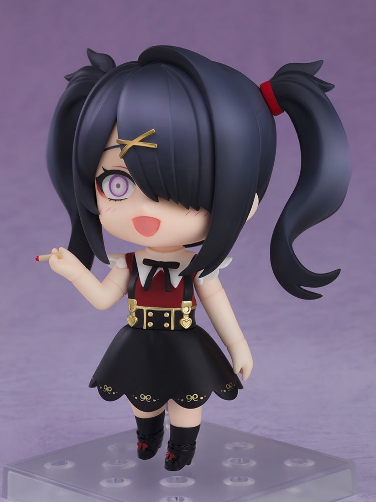 A stylized anime figure with black pigtails, purple eyes, red & black dress, smiling and holding a matchstick