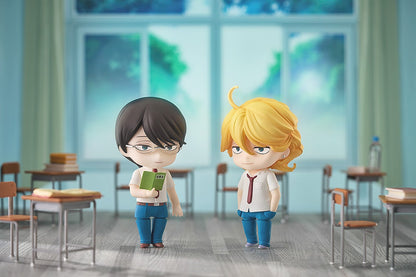 Two Nendoroid boys in a classroom: one dark-haired with glasses holds a book, the blonde one has a smirk