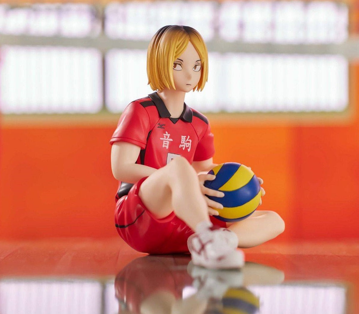 Side view of Kenma showing seated pose, with hands folded over knees